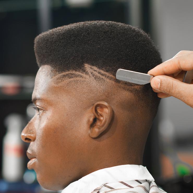 Low skin fade with textured top and smooth side transition, Campbell barbershop style.